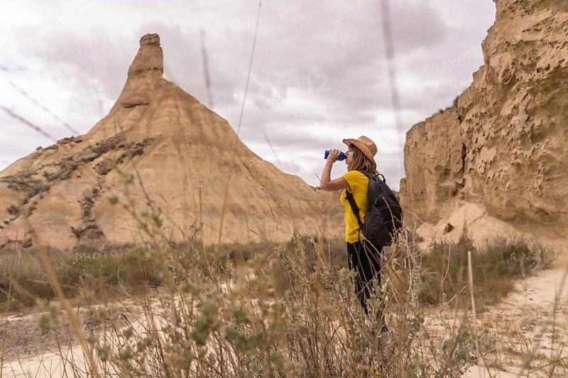 Horizontal photo with copy space of a woman using binoculars to observe wildlife in a national park