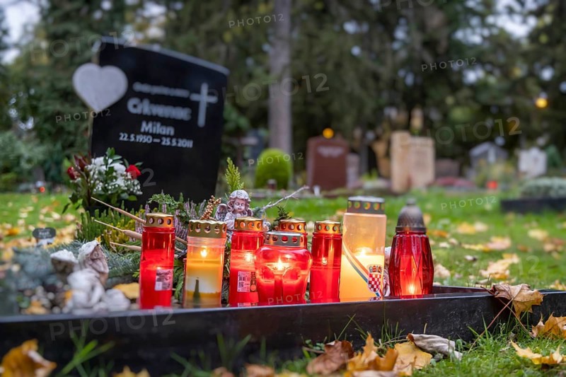 All Saints' Day at the Prague Cemetery in Stuttgart. Catholics commemorate their deceased relatives. Grave decorations and candles. Stuttgart, Baden-Württemberg, Germany