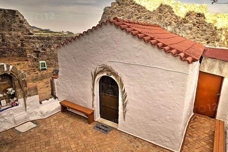 Small white chapel with tiled roof, embedded in old ruins, quiet atmosphere, natural stone, Archangelos, castle, place, castle of Archangelos, Rhodes, Dodecanese, Greek Islands, Greece