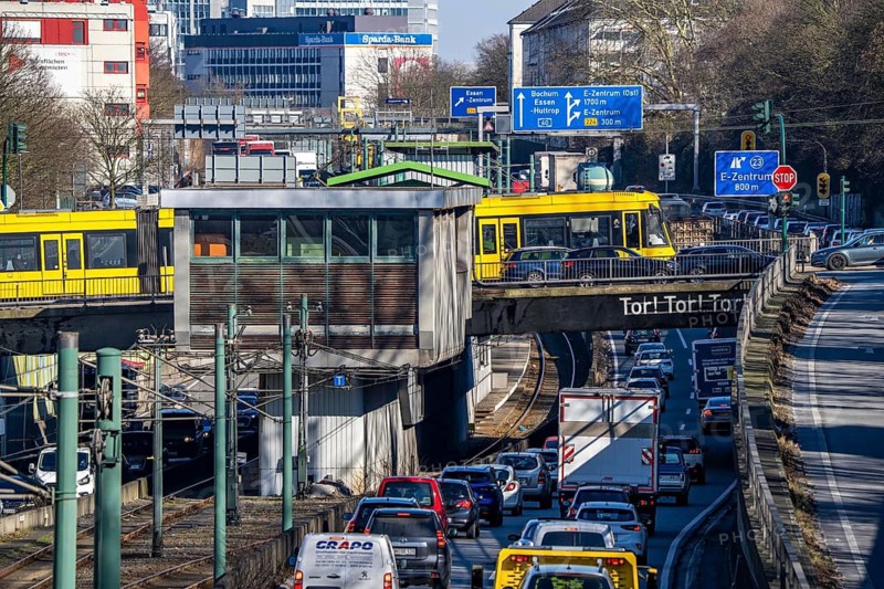 Motorway A40, Ruhr expressway, heavy traffic jam, rush hour, city passage in Essen, skyline of the city centre, underground line between the lanes, Hobeisenbrücke stop, North Rhine-Westphalia, Germany