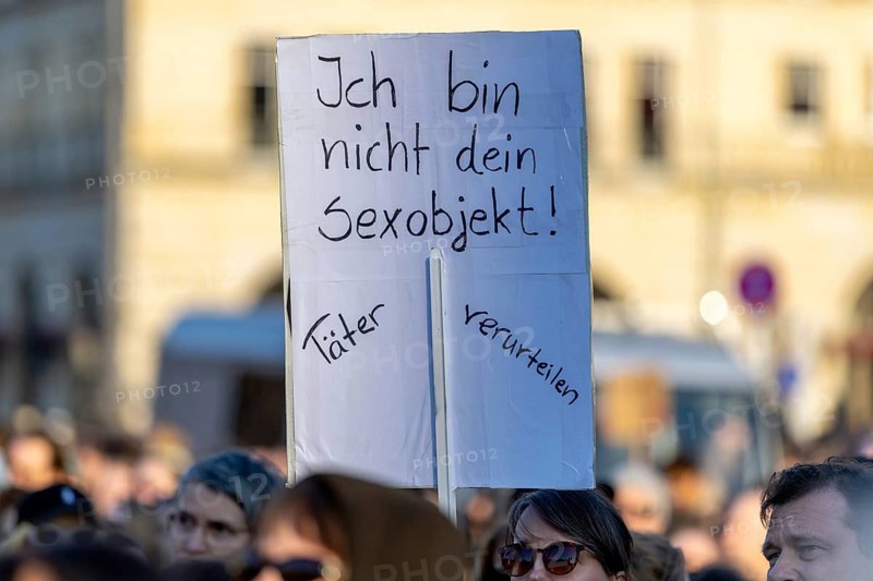Berlin, Germany - 22.3.2026: Demonstrators, including one holding up a poster with the inscription: - Violence against woman endangers democracy - protesting in front of the Brandenburg Gate under the theme Demonstration against sexualized digital violence - Solidarity with all victims and in solidarity with Collien Fernandes. A few days ago, Collien Fernandes had publicly accused her ex-man Christian Ulmen of creating and disseminating fake profiles of her pornographic content with deepfake