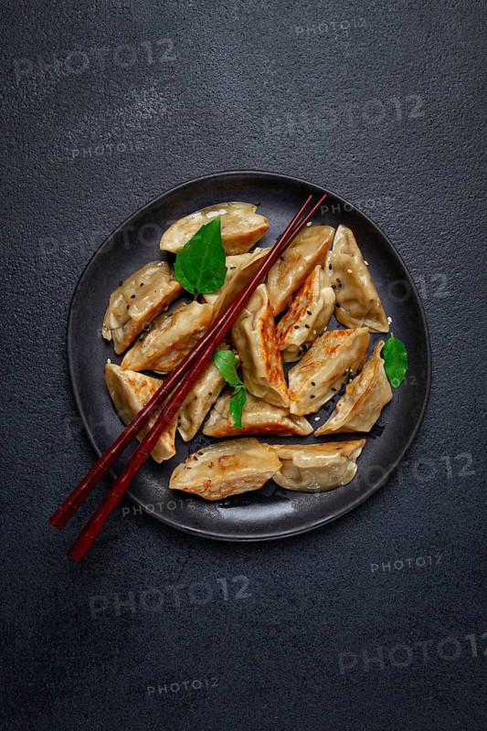 Japanese fried gyoza dumplings, with pork, sesame seeds, green onions