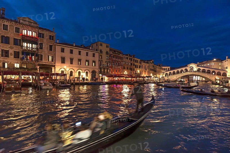 Grand Canal with Rialto Bridge in the evening, gondola in front, Venice, Veneto, Italy