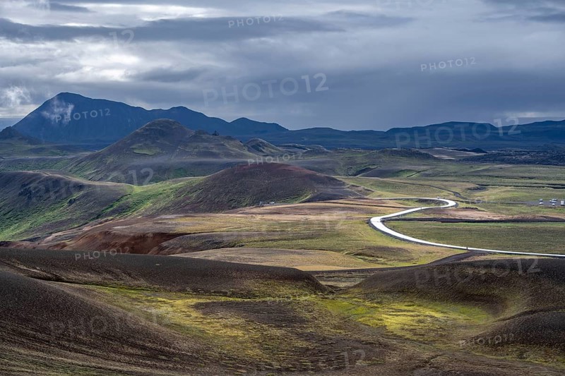 Road through volcanic landscape with colourful hills, Krafla geothermal area, Northern Iceland, Iceland