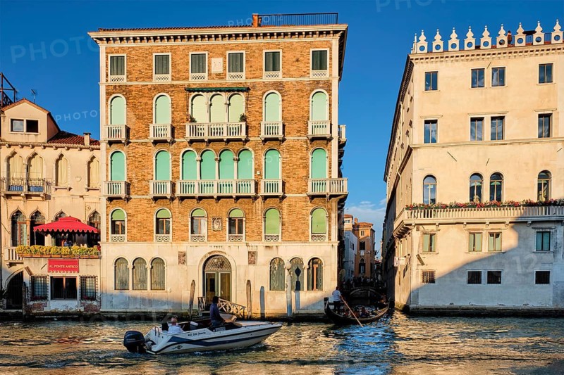 VENICE, ITALY, JUNE 27, 2018: Grand Canal with boats and gondolas on sunset, Venice, Italy