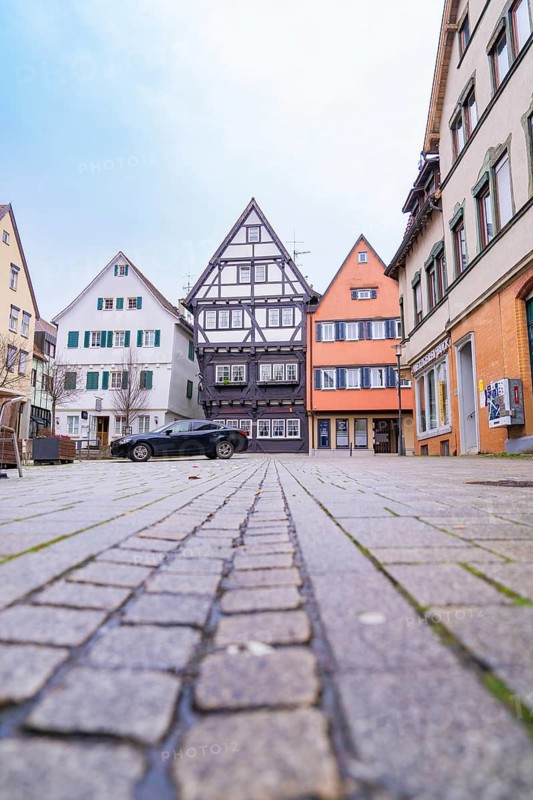 View of historic half-timbered houses along a cobbled street, cars parked at the edge, Großbottwar, Ludwigsburg district, Baden-Württemberg, Germany