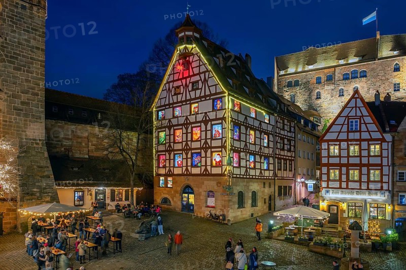 Historic Pilatus House in the evening with an Advent calendar designed by the Altstadtfreuden Nuremberg, behind the Imperial Castle, Tiegärtnertorplatz, Nuremberg, Middle Franconia, Bavaria, Germany
