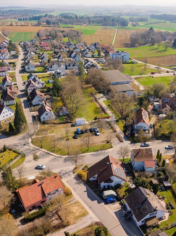 View from above of a cluster of houses in a village with surrounding streets and green surroundings, Nagold Hochdorf, district of Calw, Germany