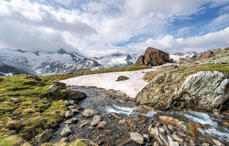 Picturesque mountain landscape with mountain stream Zemmbach, mountain peaks with snow and glacier Schwarzensteinkees and Hornkees summit Schwarzenstein and Hornspitzen, Berliner Höhenweg, Zillertal Alps, Tyrol, Austria