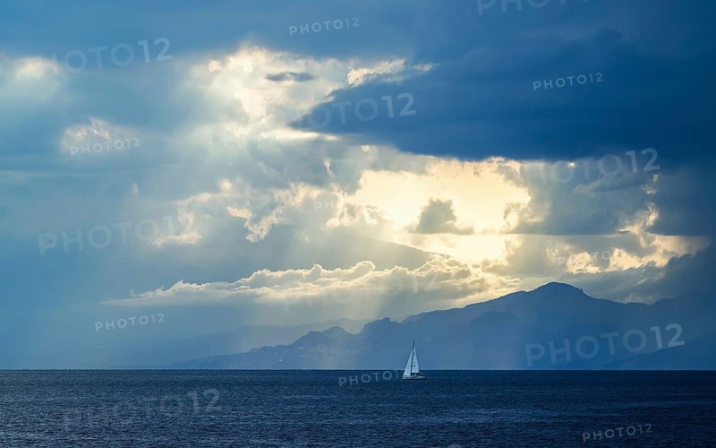Sun rays in the clouds over Sicily, Tyrrhenian Sea, Italy