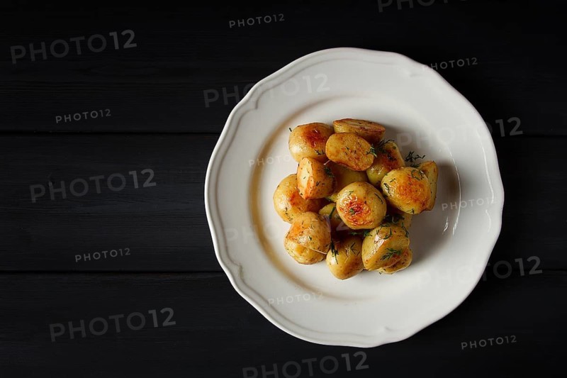 Fresh Cooked, new potatoes, with dill, on a wooden table, selective focus. close-up, toning, no people