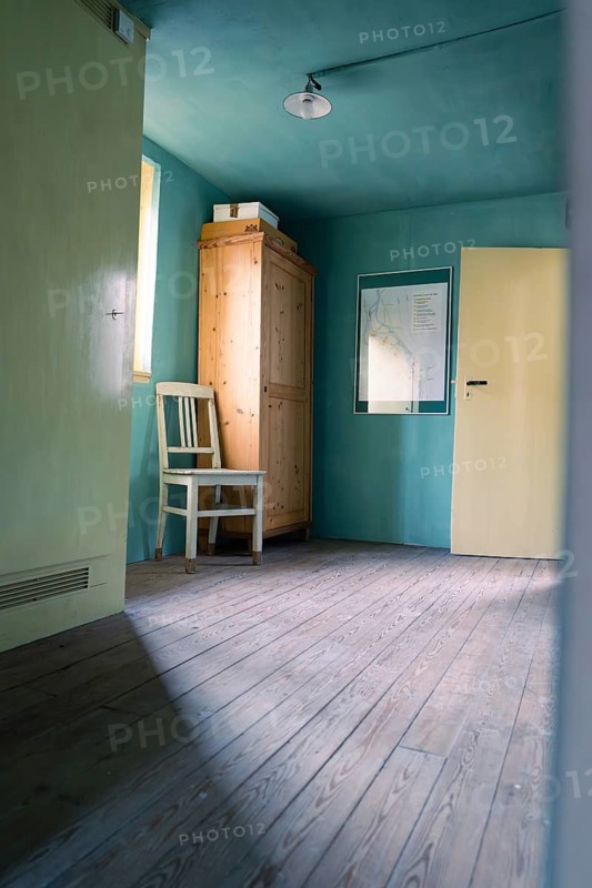 Simple room with wooden floor, green-painted walls, a chair and a cupboard, Calw Tannery Museum, Black Forest, Germany