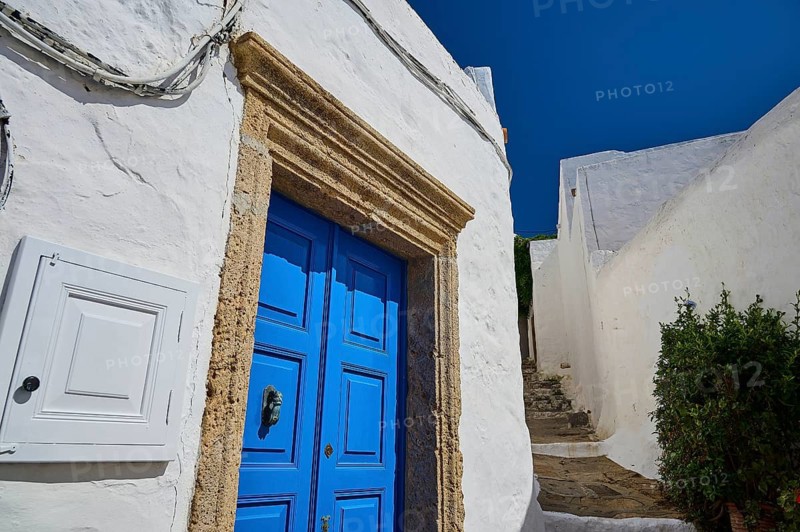 Narrow path with blue wooden door and white walls under a clear blue sky, Chora, main town Patmos, Patmos, Old Town, Dodecanese, Greek Islands, Greece