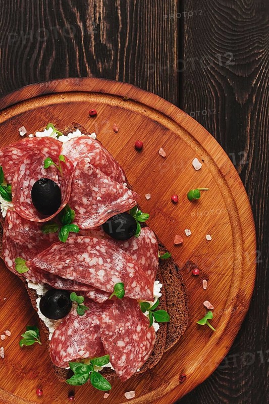 Sandwich, grain bread, with cream cheese and salami, black olives, micro-greens, top view, close-up, no people, Breakfast