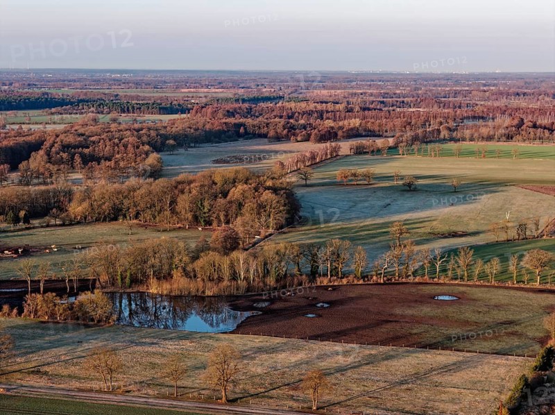 Reif lies in some fields in the countryside in the UNESCO Drömling Biosphere Reserve in the Altmark early in the morning on a cold spring day. aerial view. Dannenfeld, Gardelegen, Saxony-Anhalt, Germany