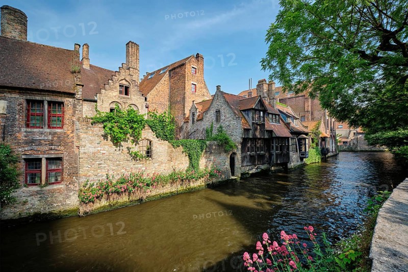Canal between old houses of famous Flemish medieval city Brugge. Bruges, Belgium