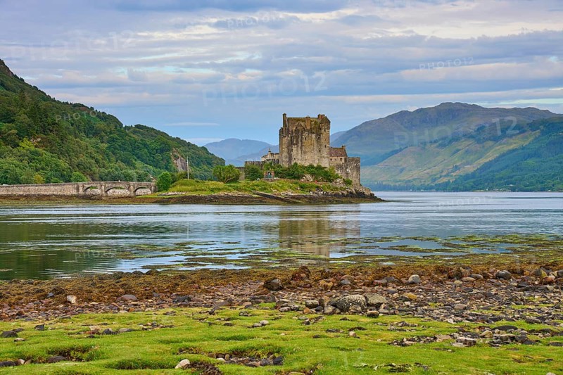Historic castle in a picturesque river landscape with lush greenery and cloudy skies, Eilean Donan Castle, Dornie, Kyle of Lochalsh, Scotland, United Kingdom, Great Britain