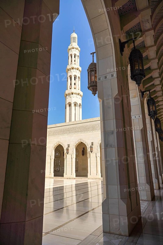 A stunning view of the architectural details at Sultan Qaboos Mosque in Muscat, Oman. The intricate design highlights the blend of traditional and modern elements
