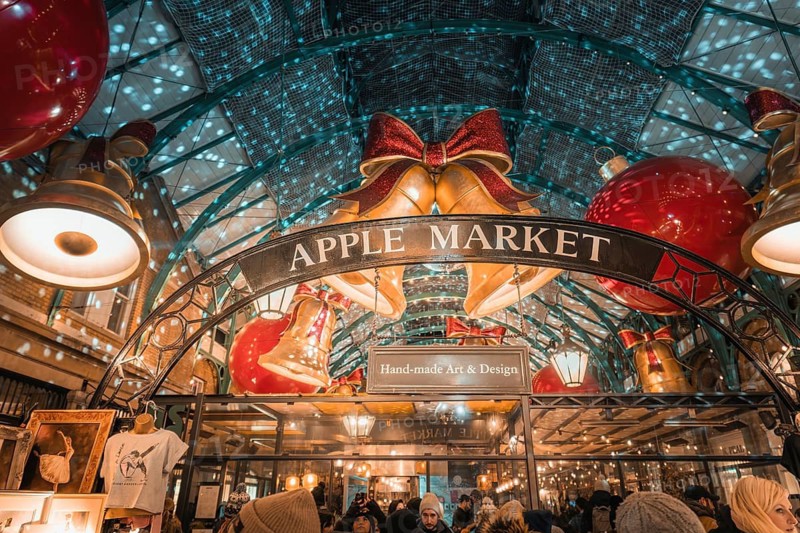 View of Apple Market entrance with big Christmas bells and lights, AppleMarket, London, United Kingdom
