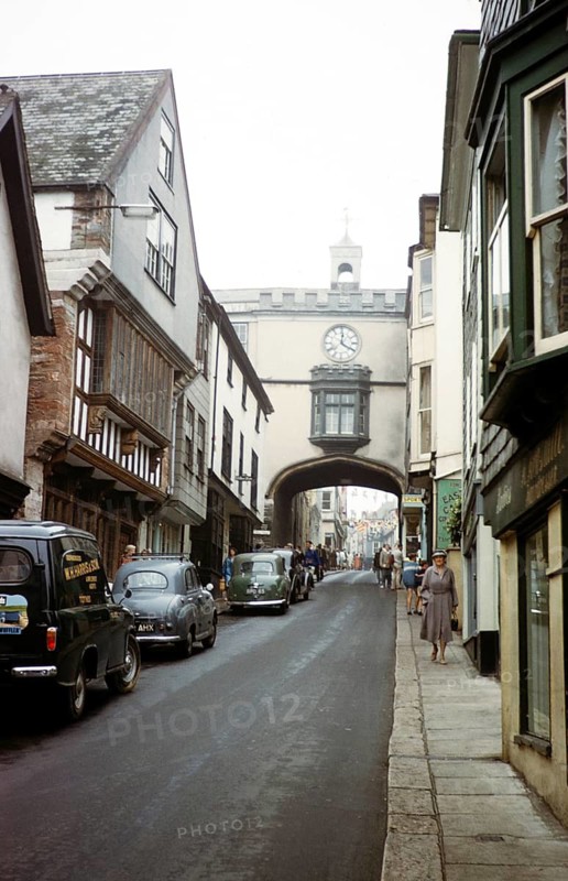 Cars and people High Street, East Gate archway, Totnes, Devon, England, United Kingdom in the early 1960s