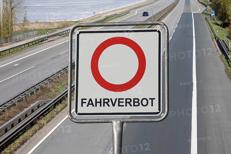 (photo montage) Sign with the inscription FAHRVERBOT exempted in front of an empty motorway
