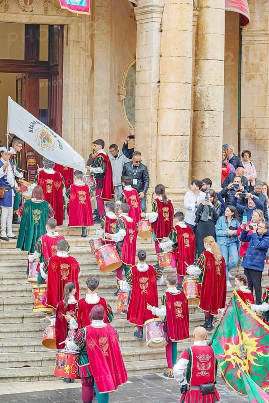 Participants wearing historical costumes entering city hall, Noto, Noto Valley, Sicily, Italy