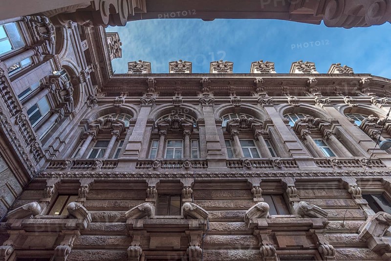 Detailed view of the courtyard façade of the Palazzo della Borsa, built between 1907 and 1912, in Piazza de Ferrari, Genoa, Italy