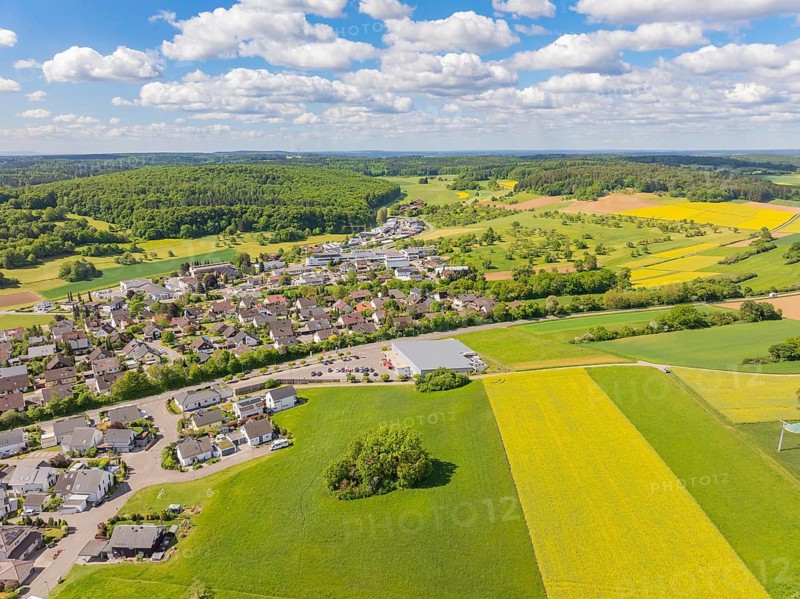 View of a village and surrounding fields and forests under a blue sky with clouds, Gechingen, Black Forest, Germany