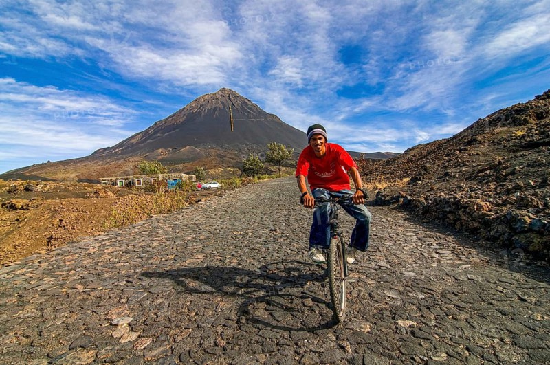 Cyclist with vulcano in background. Fogo. Cabo Verde. Africa