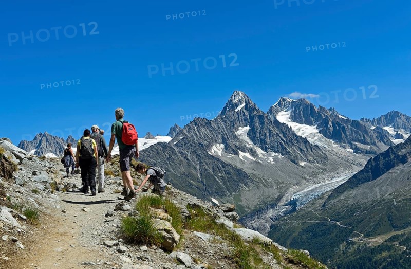 Hikers in the Chamonix hiking area on the way to the mountain lake Lac Blanc, on the right the peaks Aiguille du Chardonnet and Aiguille d'Argentière and the glacier Glacier d'Argentière, Chamonix, Haute Savoie, France