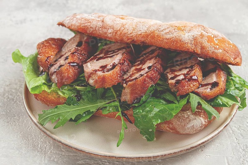 Sandwich with duck breast and arugula, balsamic sauce, on a light plate, breakfast, homemade, no people