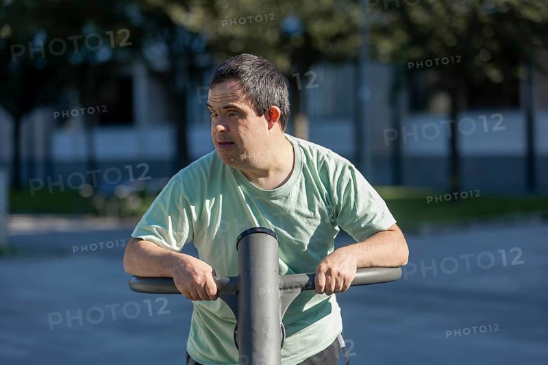 A person enjoys outdoor exercise at a community day center, focusing on well-being and engagement. Sunlight and fresh air enhance the activity's positive atmosphere