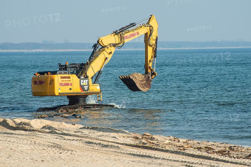 Excavator used in the repair the beach in Ystad, Ystads Saltsjöbad, a popular tourist destination, Ystad, Skåne County, Baltic Sea, Sweden, Scandinavia