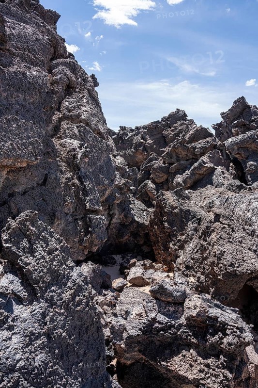 Large, weathered lava rocks under a clear blue sky, Argentina, volcanoes, lava field, Antofagasta