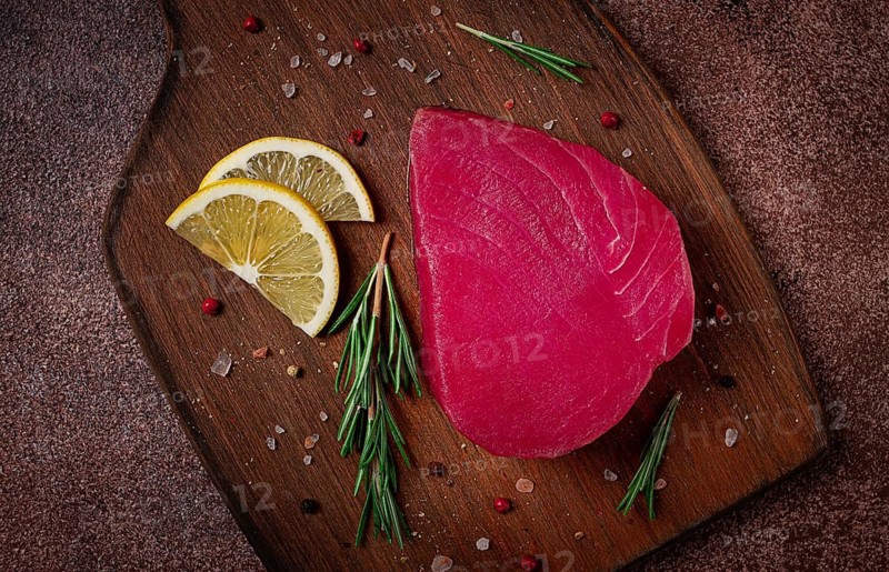 Fresh red tuna fillet, for steak, raw, top view, on a cutting board, no people