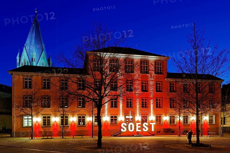 Illuminated town hall with St Patrokli Cathedral in the evening at the Winter Radiance Festival of Lights in Soest, North Rhine-Westphalia, Germany