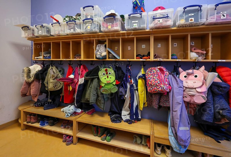 Germany - Symbolic image KITA. Children's coats, jackets and unicorn rucksacks hang on a coat rack in a kindergarten