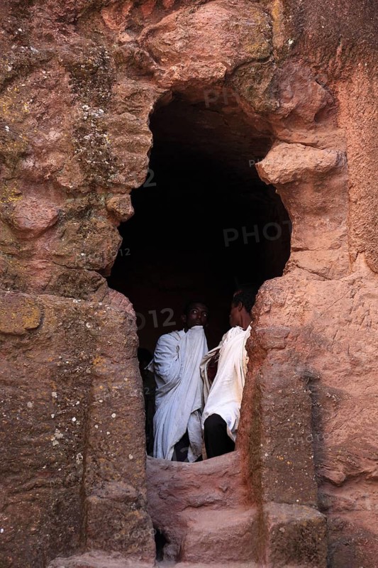 Rock churches of Lalibela, pilgrims stand at the entrance to the symbolic tomb of Adam, Ethiopia