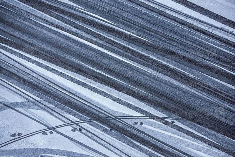 Car tire tracks and footprints in fresh snow, Schöneberg, Berlin, Germany