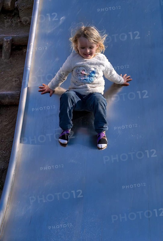 Little girl, 3 years, blonde, jumper, Disney, Elsa, ice queen, slides on slide, playground, Stuttgart, Baden-Württemberg, Germany