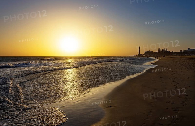 Sunset at the beach of Maspalomas with lighthouse Faro de Maspalomas, Gran Canaria, Canary Islands, Spain, Atlantic Ocean