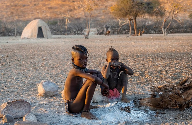 Himba children at an early morning fire, traditional Himba village, Kaokoveld, Kunene, Namibia