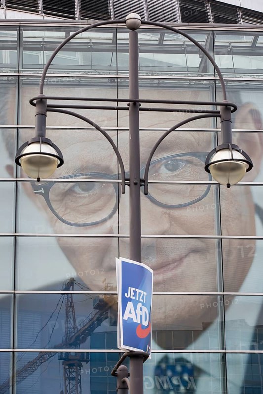 An election poster of the far-right AfD party (now AfD) hangs in front of a portrait of Friedrich Merz, the party chairman of the CDU, in front of the Konrad Adenauer House. Just after the 80th anniversary of the liberation of the Auschwitz concentration camp, the CDU chairman tabled a motion in favour of a tougher migration policy, which was only won thanks to the votes of the AfD. Berlin, 01.02.2025