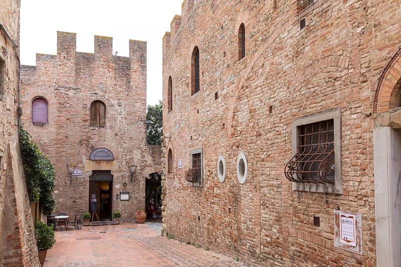Narrow alleyways and houses decorated with battlements in the old town centre of Certaldo, Tuscany, Italy