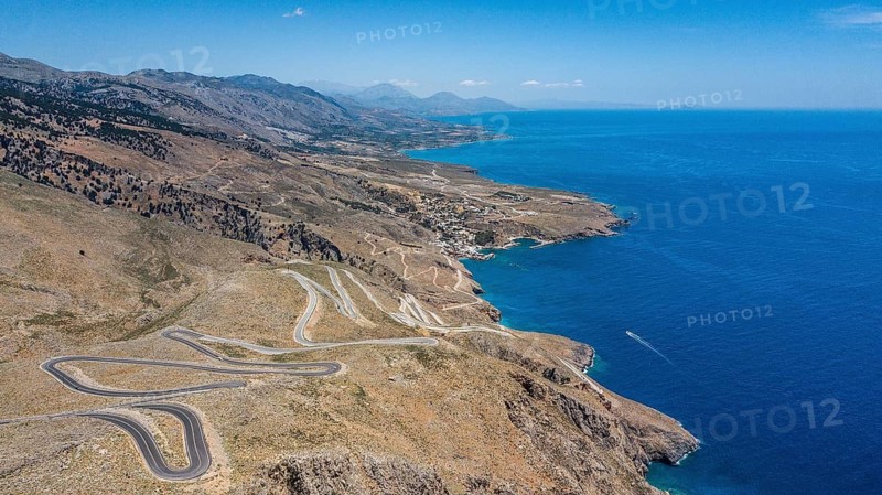 Aerial view of pass road serpentines from to Passo Anopoli above south coast of Crete right Libyan Sea Mediterranean Sea near Sfakia, Chora Sfakion, Crete, Greece