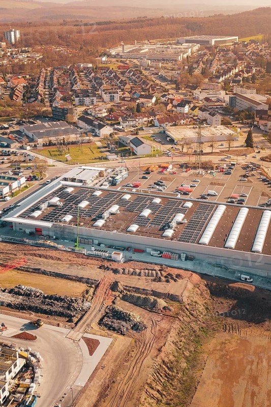 Aerial view of an industrial complex with solar systems and parking spaces in an urban area, PV Bau Auf OBI Bau Markt, Mühlacker, Enzkreis, Germany