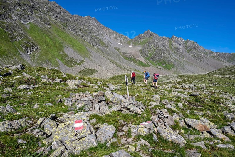 Three hikers in the Alps, Lasörling High Trail, Lasörling Group, Hohe Tauern National Park, East Tyrol, Tyrol, Austria