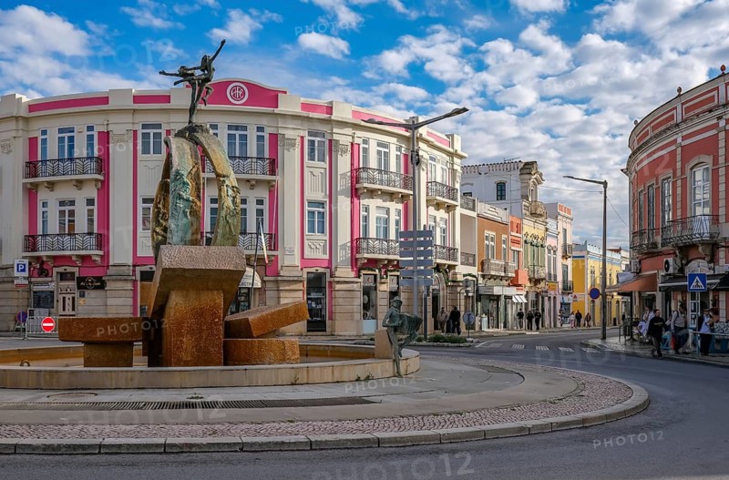 Loule, Algarve, Portugal - Houses with colourful facades in the old town of Loulé, roundabout with fountain in the town centre