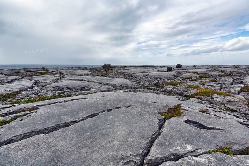 Bizarrely shaped limestone slabs, hiking trail along the coastline, limestone coast of the Burren, Murrooghtoohy viewpoint, County Clare, Wild Atlantic Way, Atlantic Ocean, Ireland