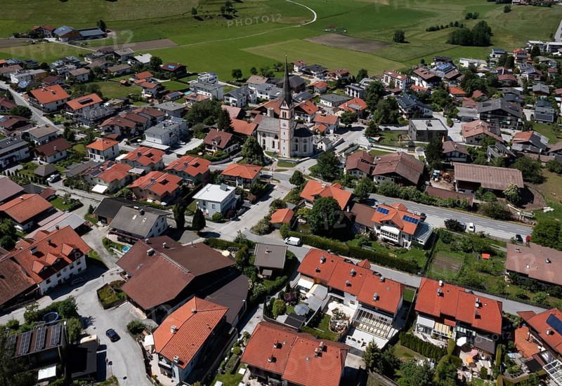 Drone shot, view of the village with parish church, Rinn, Tyrol, Austria
